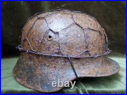 German Original. Wehrmacht soldier helmet with camouflage net. 1936-1945