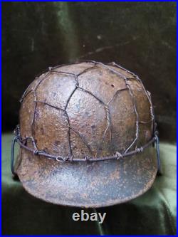 German Original. Wehrmacht soldier helmet with camouflage net. 1936-1945