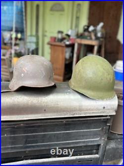 German Stahlhelm, M35 or M40 model, U. S. M1 helmet World War II German Stahlhelm, M35 or M40 model, U. S. M1 helmet World War II