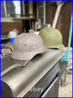 German Stahlhelm, M35 or M40 model, U. S. M1 helmet World War II German Stahlhelm, M35 or M40 model, U. S. M1 helmet World War II