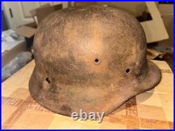 WWII German foot soldier helmet bullet shrapnel hole WWII WW2 world war