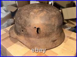 WWII German foot soldier helmet bullet shrapnel hole WWII WW2 world war