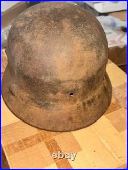 WWII German foot soldier helmet bullet shrapnel hole WWII WW2 world war