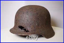 WWII WW2 German soldier M35 Helmet with battle damaged from Kurland #152 WWII WW2 German soldier M35 Helmet with battle damaged from Kurland #152