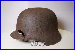 WWII WW2 German soldier M35 Helmet with battle damaged from Kurland #152 WWII WW2 German soldier M35 Helmet with battle damaged from Kurland #152