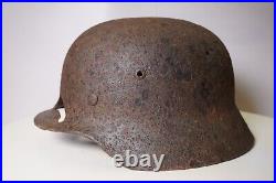 WWII WW2 German soldier M35 Helmet with battle damaged from Kurland #152 WWII WW2 German soldier M35 Helmet with battle damaged from Kurland #152