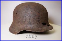 WWII WW2 German soldier M35 Helmet with battle damaged from Kurland #152 WWII WW2 German soldier M35 Helmet with battle damaged from Kurland #152