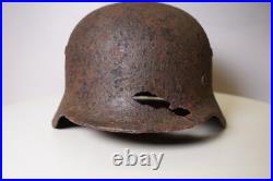 WWII WW2 German soldier M35 Helmet with battle damaged from Kurland #152 WWII WW2 German soldier M35 Helmet with battle damaged from Kurland #152