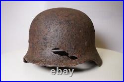 WWII WW2 German soldier M35 Helmet with battle damaged from Kurland #152 WWII WW2 German soldier M35 Helmet with battle damaged from Kurland #152