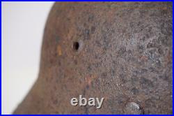 WWII WW2 German soldier M35 Helmet with battle damaged from Kurland #152 WWII WW2 German soldier M35 Helmet with battle damaged from Kurland #152